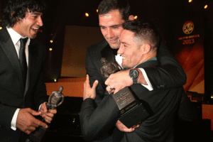 Cooper Cronk is congratulated by Johnathan Thurston and Cameron Smith after winning the Dally M award. Photo / Getty