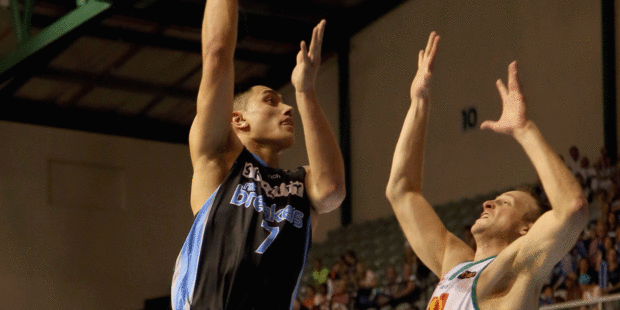 Reuben Te Rangi shoots over Jacob Holmes as part of an energetic display during the Breakers' clash with Townsville tonight. Photo / Getty