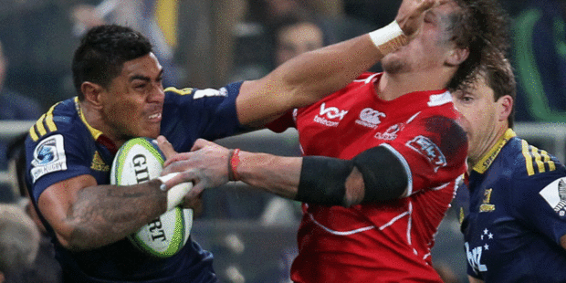 Malakai Fekitoa fends away a would-be tackler in the Highlanders' narrow win over the Lions in Dunedin. Photo / Getty