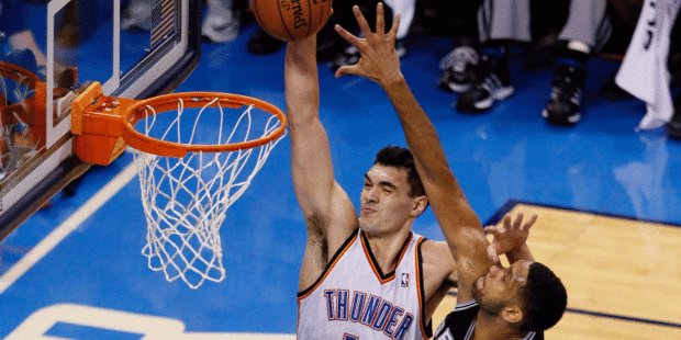 Steven Adams fends off the attentions of Tim Duncan to dunk during the Thunder's game four victory. Photo / Getty