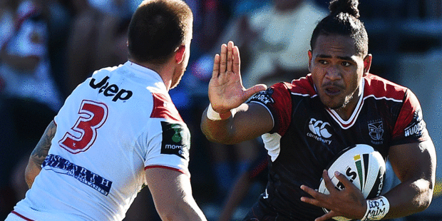 Warriors centre Solomone Kata looks to fend his Dragons opposite in their 2015 preseason trial. Photo / Photosport