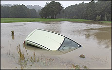 The car remained almost submerged after yesterday's rescue. Picture / Richard Robinson The car remained almost submerged after yesterday's rescue. Picture / Richard Robinson