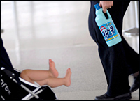 An airline staff member with a bottle of detergent confiscated after Thursday's terror threat. Picture / Reuters An airline staff member with a bottle of detergent confiscated after Thursday's terror threat. Picture / Reuters