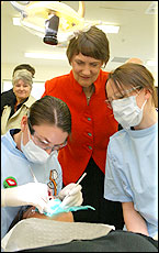 Helen Clark watches AUT dental therapy students Leanne Adair (left) and Tanya Hillyard examine Nancy Croft, 16. Picture / Glenn Jeffrey Helen Clark watches AUT dental therapy students Leanne Adair (left) and Tanya Hillyard examine Nancy Croft, 16. Picture / Glenn Jeffrey