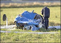 An investigator checks the wreckage of one of the planes involved in the mid-air collision. Marty Melville / Getty Images An investigator checks the wreckage of one of the planes involved in the mid-air collision. Marty Melville / Getty Images