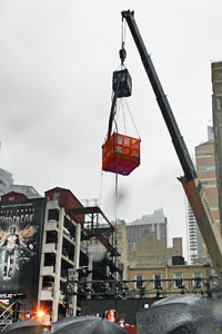 Fans watch as magician Criss Angel is sealed in a box filling with wet cement during a stunt in New York. Photo / Reuters Fans watch as magician Criss Angel is sealed in a box filling with wet cement during a stunt in New York. Photo / Reuters