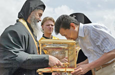 Head of the Russian republic of Kalmykia, Kirsan Ilyumzhinov, seen here kissing relics of St Luke the Evangelist, insists he was abducted by aliens in September 1997. Photo / Reuters Head of the Russian republic of Kalmykia, Kirsan Ilyumzhinov, seen here kissing relics of St Luke the Evangelist, insists he was abducted by aliens in September 1997. Photo / Reuters