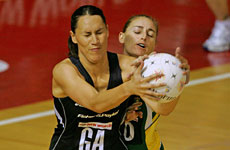 Silver Fern goal attack Jodi Te Huna wrestles for possession with a South African player during their quarterfinal. Photo / Brett Phibbs Silver Fern goal attack Jodi Te Huna wrestles for possession with a South African player during their quarterfinal. Photo / Brett Phibbs