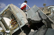 A man inspects a tomb at the cemetery in the outskirts of Tocopilla town some 1559 km (968 miles) north of Santiago two days ago. Photo / Reuters A man inspects a tomb at the cemetery in the outskirts of Tocopilla town some 1559 km (968 miles) north of Santiago two days ago. Photo / Reuters