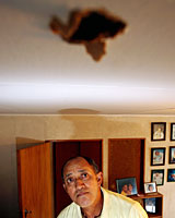 George Cunningham and the hole in his ceiling. Photo / Hawkes Bay Today George Cunningham and the hole in his ceiling. Photo / Hawkes Bay Today