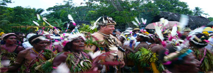 Clad in a necklace of dog's teeth and a headdress of pig tusks, Justin Friend is initiated as a chief of the PNG village of Watam. Photo / Jim Eagles Clad in a necklace of dog's teeth and a headdress of pig tusks, Justin Friend is initiated as a chief of the PNG village of Watam. Photo / Jim Eagles