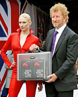 British author Sebastian Faulks poses with a model, as he holds a case containing the first seven copies of his new James Bond book, entitled Devil May Care. Photo / Reuters British author Sebastian Faulks poses with a model, as he holds a case containing the first seven copies of his new James Bond book, entitled Devil May Care. Photo / Reuters
