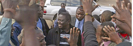 Morgan Tsvangirai (C) is greeted by supporters during a visit to a Harare suburb. Photo / Reuters Morgan Tsvangirai (C) is greeted by supporters during a visit to a Harare suburb. Photo / Reuters