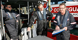 Todd Forsyth (left) and Ian Gibson tell Mark Gosche (centre) what the Coastguard deals with. Photo / Greg Bowker Todd Forsyth (left) and Ian Gibson tell Mark Gosche (centre) what the Coastguard deals with. Photo / Greg Bowker