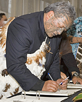 Tame Iti signing the Ngai Tuhoe terms of negotiation agreement. Photo / Mark Mitchell Tame Iti signing the Ngai Tuhoe terms of negotiation agreement. Photo / Mark Mitchell