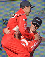 Scott Dixon is congratulated by rival Helio Castroneves (R) after winning the Indycar series today. Photo / AP Scott Dixon is congratulated by rival Helio Castroneves (R) after winning the Indycar series today. Photo / AP