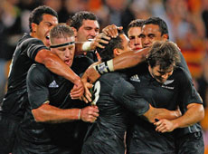 Team-mates congratulate Dan Carter after he dots down. Photo / Getty Images Team-mates congratulate Dan Carter after he dots down. Photo / Getty Images