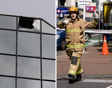 A firefighter directs the public away from the AMI building after a window pane (L) fell to the street. Photos / Dean Purcell A firefighter directs the public away from the AMI building after a window pane (L) fell to the street. Photos / Dean Purcell