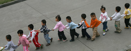 Children at a kindergarten in China walk in snake formation. Photo / Getty Images Children at a kindergarten in China walk in snake formation. Photo / Getty Images