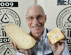 Master judge Neil Willman with the 2009 NZ Champions of Cheese: Mercer Extra Mature Gouda with Cumin (L) and Over the Moon Dairy Company Galactic Gold washed rind cheese (R). Photo / Supplied Master judge Neil Willman with the 2009 NZ Champions of Cheese: Mercer Extra Mature Gouda with Cumin (L) and Over the Moon Dairy Company Galactic Gold washed rind cheese (R). Photo / Supplied