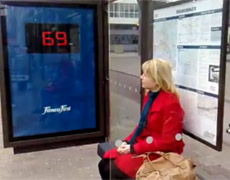 A woman's weight is displayed as she sits in a Rotterdam bus stop. A woman's weight is displayed as she sits in a Rotterdam bus stop.