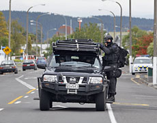 Officers from the armed offenders squad or special tactics group are carried to the cordon on the corner of Carlyle and Faraday Sts. Photo / Sarah Ivey Officers from the armed offenders squad or special tactics group are carried to the cordon on the corner of Carlyle and Faraday Sts. Photo / Sarah Ivey