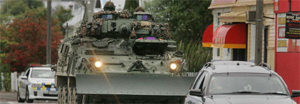 An armoured vehicle escorted by a police car heads into the cordoned area of Napier today. Photo / Alan Gibson An armoured vehicle escorted by a police car heads into the cordoned area of Napier today. Photo / Alan Gibson