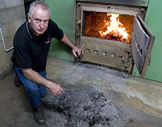 Peter Langdale with Macleans College's converted coal-fired burner. Photo / Richard Robinson Peter Langdale with Macleans College's converted coal-fired burner. Photo / Richard Robinson