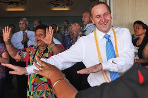 John Key gets into the swing of things at the Matavai Resort on Niue. Photo / Getty Images