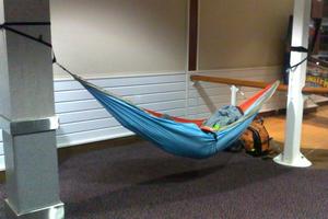 This traveller took his comfort seriously, stringing up a hammock between two pillars for his airport slumber. Photo / Supplied