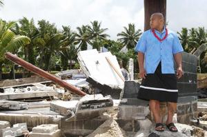 David Tua, whose aunt died in last week's tragedy, stands in the rubble of the Sinalei Resort. Photo / Greg Bowker