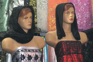 Mannequins clad in figure-hugging strapless gowns and black headwear on display in Shiraz bazaar. Photo / Jill Worrall
