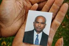 A relative holds a photo of Jasmatbhai Patel. Photo / Greg Bowker A relative holds a photo of Jasmatbhai Patel. Photo / Greg Bowker