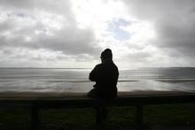 Ghanshyan Patel, sits near his home at Red Beach, Whangaparoa and watches for the tsunami to hit. Photo / Glenn Jeffrey Ghanshyan Patel, sits near his home at Red Beach, Whangaparoa and watches for the tsunami to hit. Photo / Glenn Jeffrey
