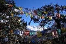 Prayer flags flutter high in the snow-capped Himalayas. Photo / Jim Eagles Prayer flags flutter high in the snow-capped Himalayas. Photo / Jim Eagles