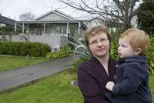 Kate Holgate and son Jack in front of a house she tried to buy in a 'part exchange' deal with her own house in Torbay. Photo / Paul Estcourt Kate Holgate and son Jack in front of a house she tried to buy in a 'part exchange' deal with her own house in Torbay. Photo / Paul Estcourt