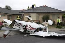 The Cessna plunged into a residential street after the collision. Photo / Mark Mitchell The Cessna plunged into a residential street after the collision. Photo / Mark Mitchell
