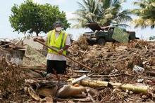 A volunteer earlier this month looking for bodies after the devastating tsunami in Samoa. Photo / Brett Phibbs A volunteer earlier this month looking for bodies after the devastating tsunami in Samoa. Photo / Brett Phibbs