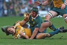 Springbok flanker Heinrich Brussow tackles Luke Burgess of the Wallabies during this morning's Tri-Nations test in Cape Town. Photo / Getty Images Springbok flanker Heinrich Brussow tackles Luke Burgess of the Wallabies during this morning's Tri-Nations test in Cape Town. Photo / Getty Images