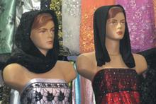 Mannequins clad in figure-hugging strapless gowns and black headwear on display in Shiraz bazaar. Photo / Jill Worrall Mannequins clad in figure-hugging strapless gowns and black headwear on display in Shiraz bazaar. Photo / Jill Worrall