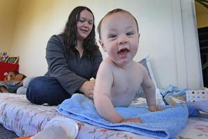Malachi McCall gets a massage from his mother Jonelle main at Te Tohu O Te Ora O Ngati Awa. Photo / Alan Gibson