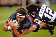 Canterbury's Sam Whitelock scores in the tackle of Richard Buckman last night. Photo / Getty Images Canterbury's Sam Whitelock scores in the tackle of Richard Buckman last night. Photo / Getty Images