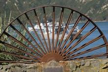 A half wheel memorial at Oyster Bay commemorates the area's history as the site of a shore-whaling station. Photo / Steve Sole A half wheel memorial at Oyster Bay commemorates the area's history as the site of a shore-whaling station. Photo / Steve Sole