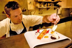 Head chef Ben Bayly puts the final touches on desserts at The Grove. Photo / Babiche Martens