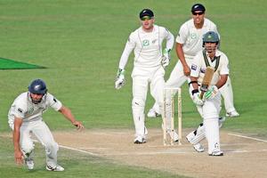 Salman Butt of Pakistan works the ball past Daniel Flynn of New Zealand during day three. Photo / Getty Images