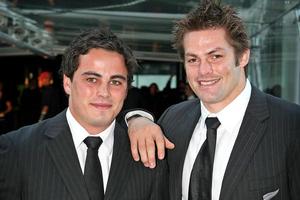 Zac Guildford (left) and Richie McCaw have good reason to take a celebratory drink at SkyCity last night. Photo / Greg Bowker