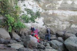 Westpac Helicopter rescue crew attend to the golfer who fell over the cliff. Photo / Supplied