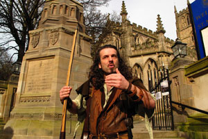 Leading a tour of Nottingham, actor Ade Andrews, dressed as Robin Hood, pauses at the gates of St. Maryís Church. Photo / Supplied