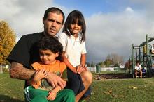 Ex-gang member Paku Waara with his children Exodus (left) and Teaotaihi at the Cutler Crescent reserve. Photo / Alan Gibson Ex-gang member Paku Waara with his children Exodus (left) and Teaotaihi at the Cutler Crescent reserve. Photo / Alan Gibson