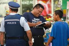 Truancy officer Tai Marsters and police officer Nicko Ng Wun get Puke Paparu's particulars. Photo / Steven McNicholl Truancy officer Tai Marsters and police officer Nicko Ng Wun get Puke Paparu's particulars. Photo / Steven McNicholl